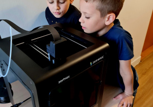 Uczniowie na zajęciach "Programowanie z elementami robotyki" poznają działanie i mozliwości drukarki 3D.